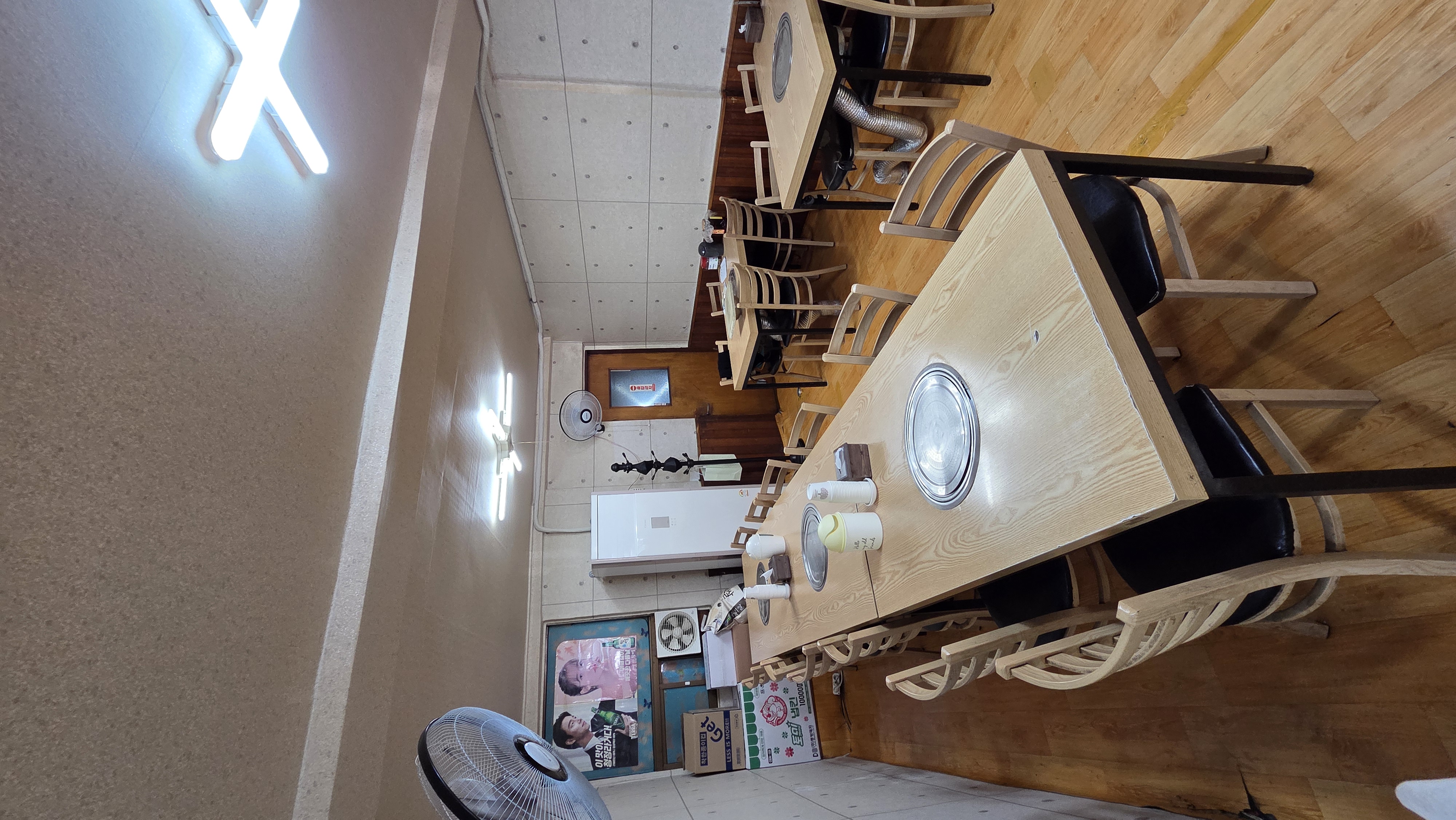 Interior seats with round grilling braziers at each table and an emergency-exit door